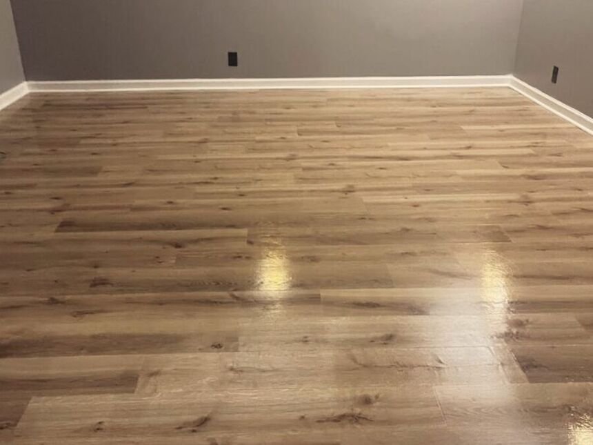 A finished remodeled room with new flooring and painted walls