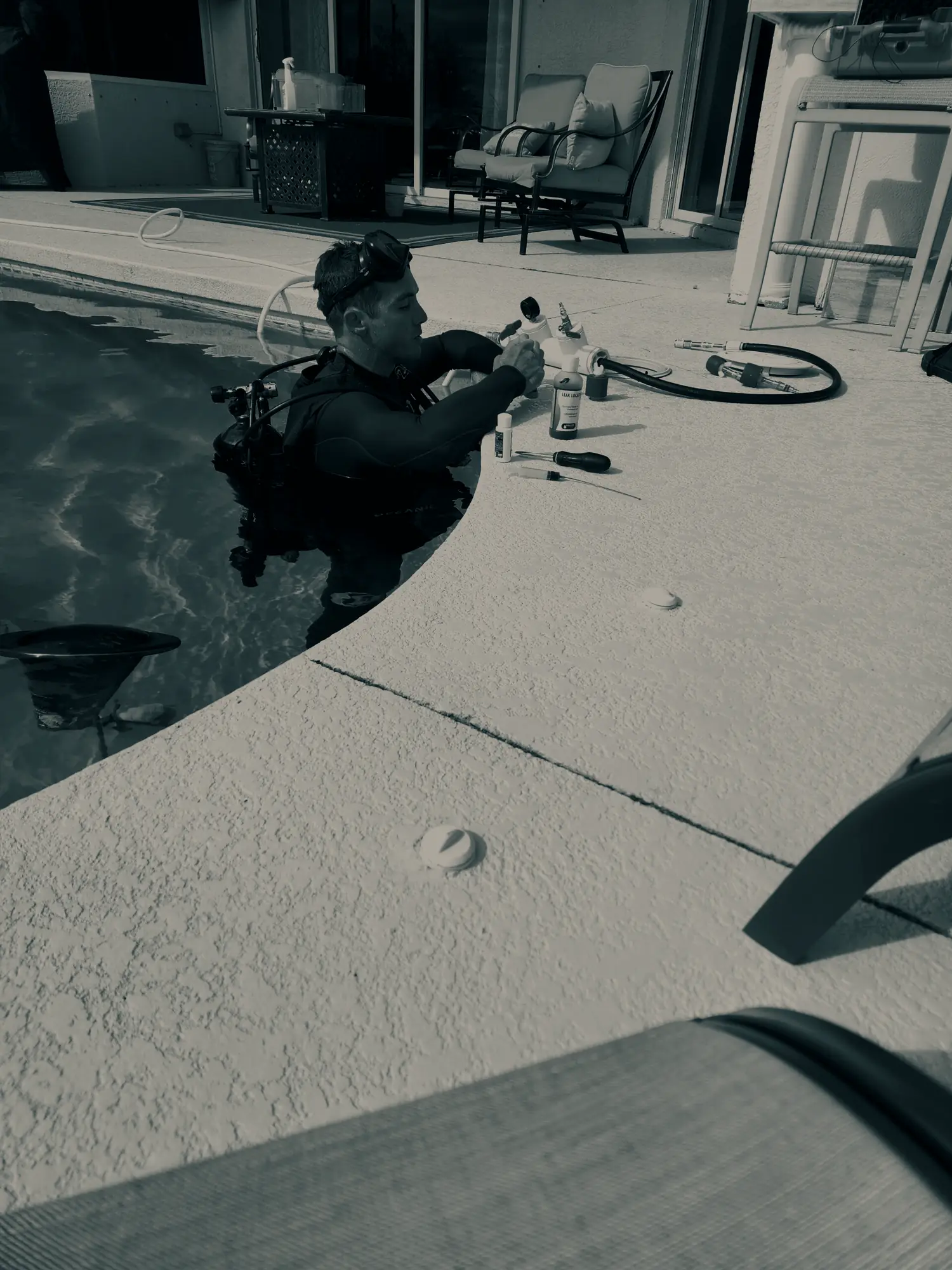 A Splash technician in full scuba gear working in a Southwest Florida pool